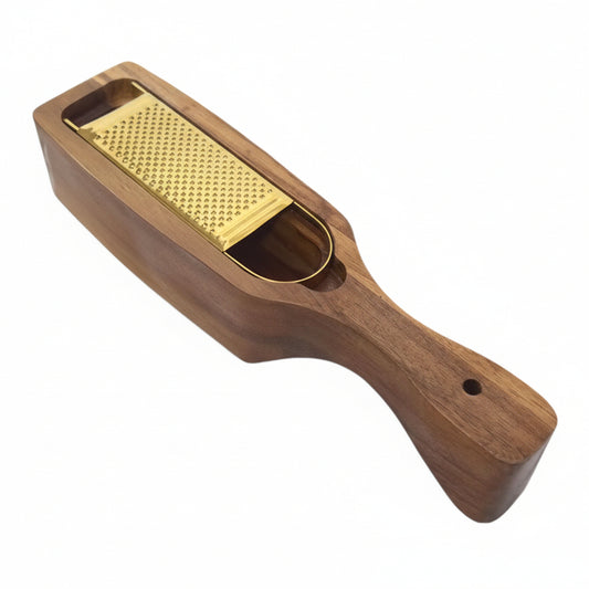 A wooden hand grater with a gold-colored metal grating surface, shown on a plain white background.